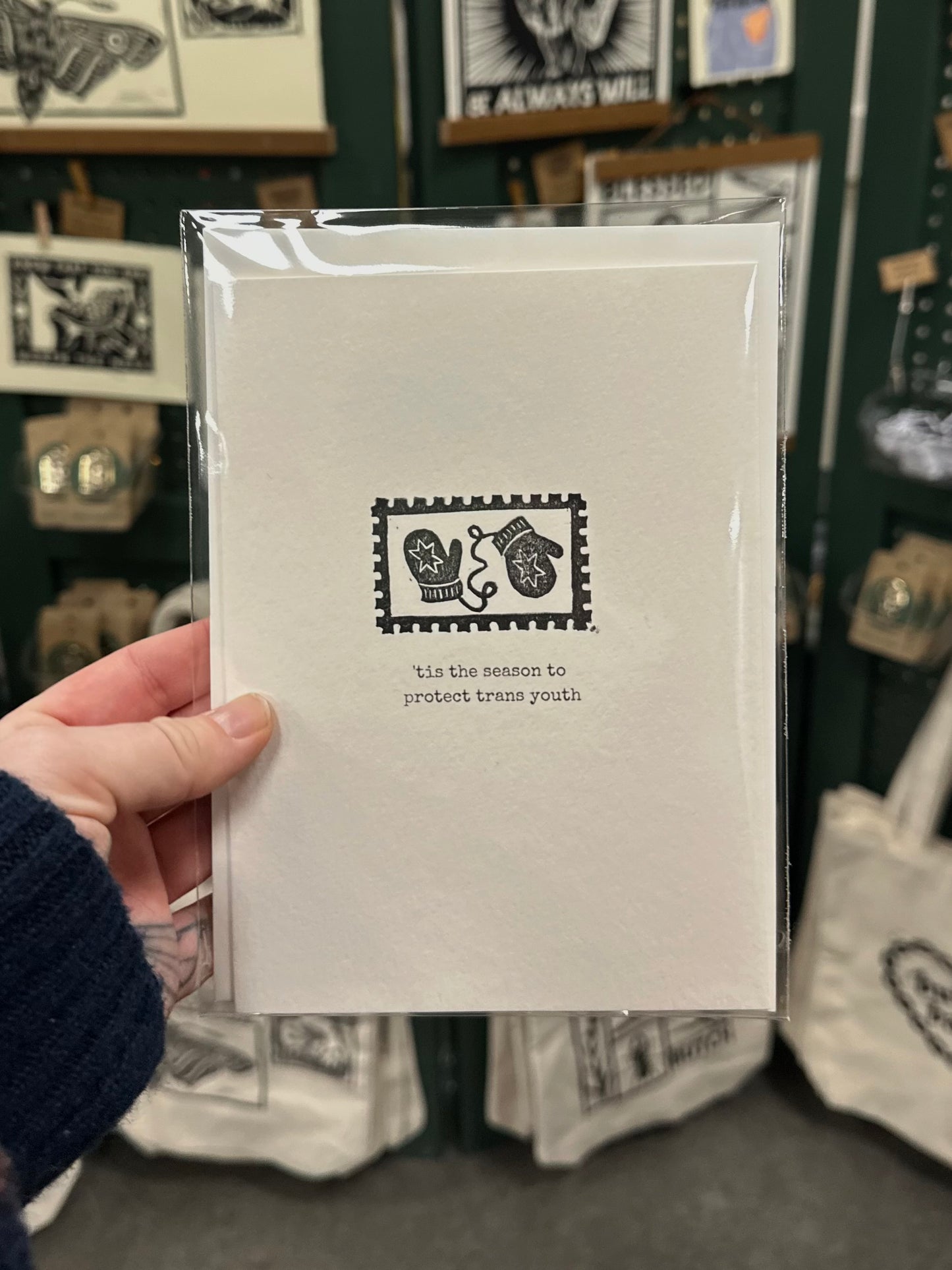 tis the season to protect trans youth postage stamp linocut holigay card