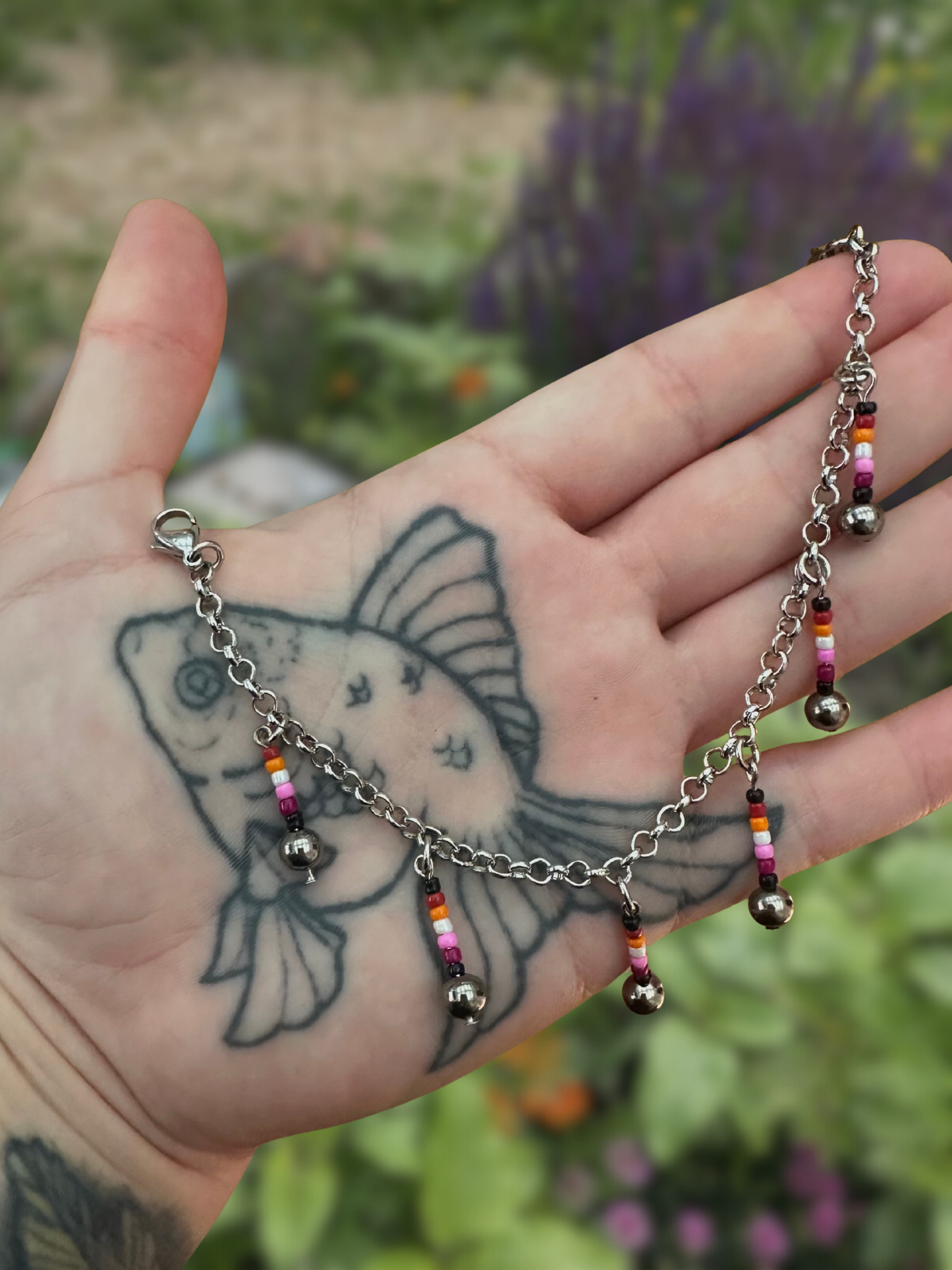 silver mask chain with lesbian flag dangles