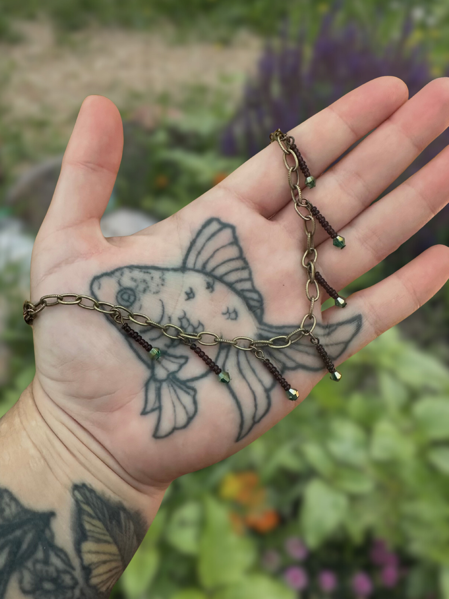 antique style mask chain with green sparkles